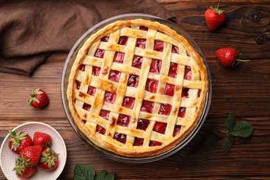 Photo of Tasty strawberry pie on wooden table, flat lay