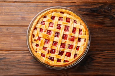 Photo of Tasty strawberry pie on wooden table, top view