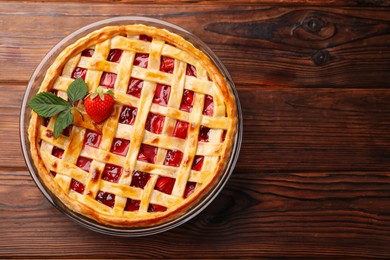 Photo of Tasty strawberry pie on wooden table, top view. Space for text