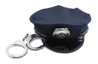 Photo of Police cap and handcuffs on white background