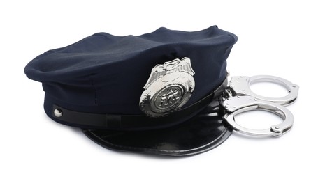 Photo of Police cap and handcuffs on white background