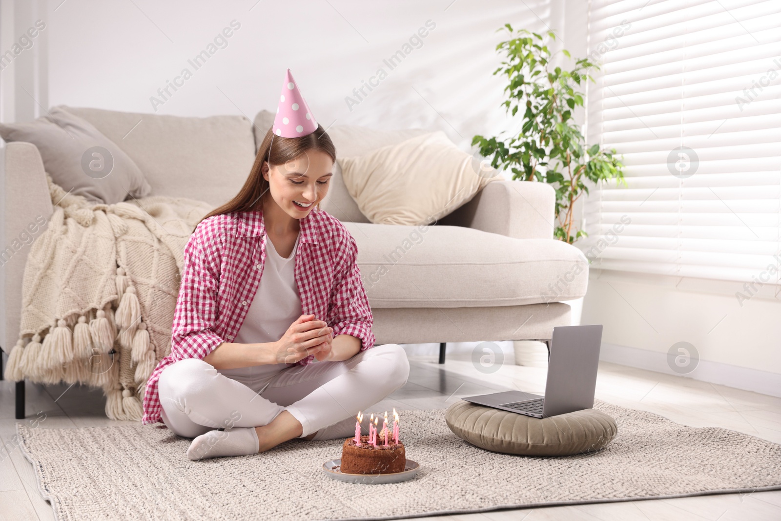 Birthday celebration. Happy woman with tasty cake having video call via laptop at home Photo of Birthday celebration. Happy woman with tasty cake having video call via laptop at home