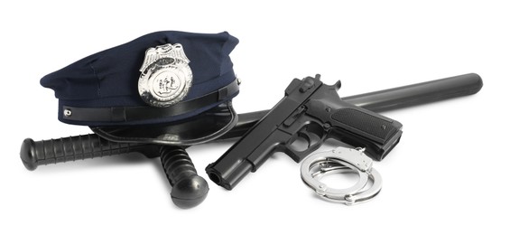 Photo of Police cap, gun, handcuffs and baton on white background