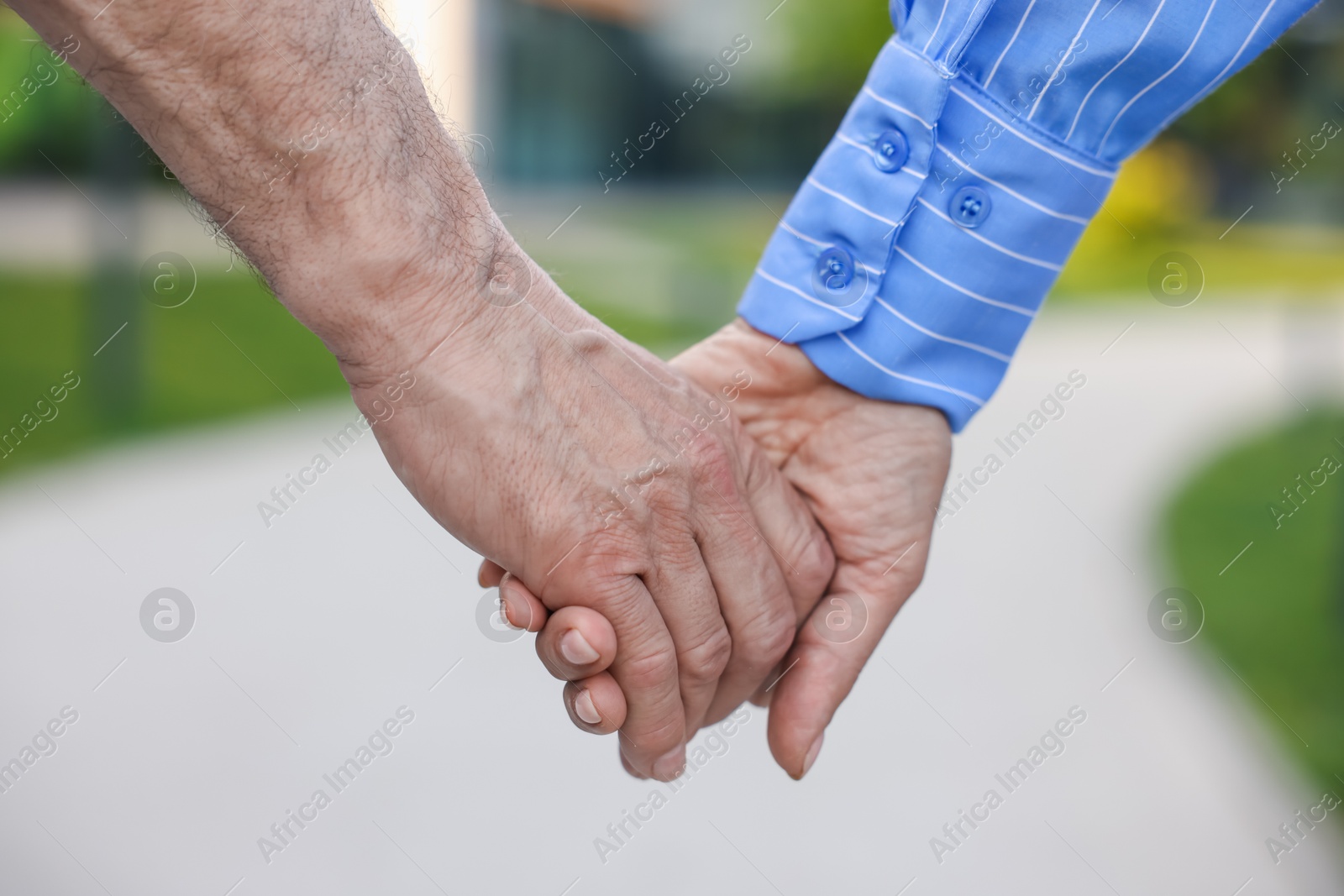 Lovely senior couple walking together outdoors, closeup Photo of Lovely senior couple walking together outdoors, closeup