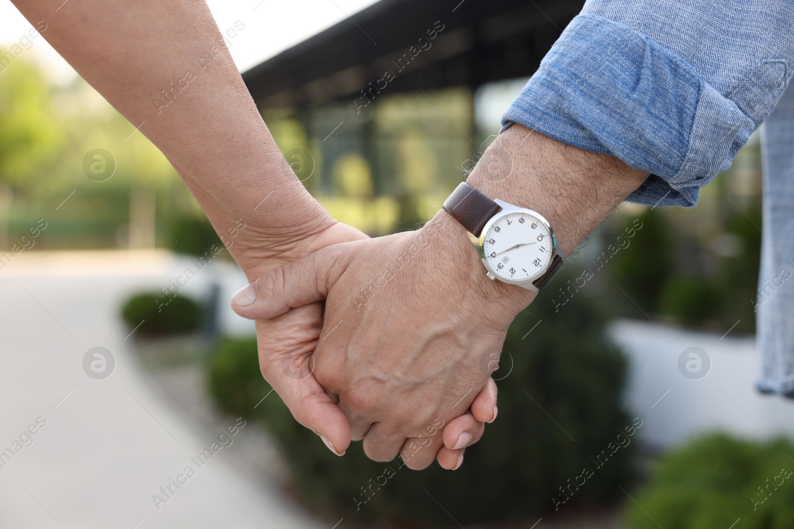 Lovely senior couple walking together outdoors, closeup Photo of Lovely senior couple walking together outdoors, closeup