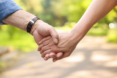 Photo of Lovely senior couple walking together outdoors, closeup