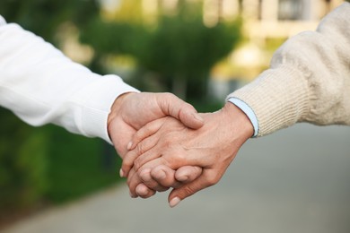 Photo of Lovely senior couple walking together outdoors, closeup