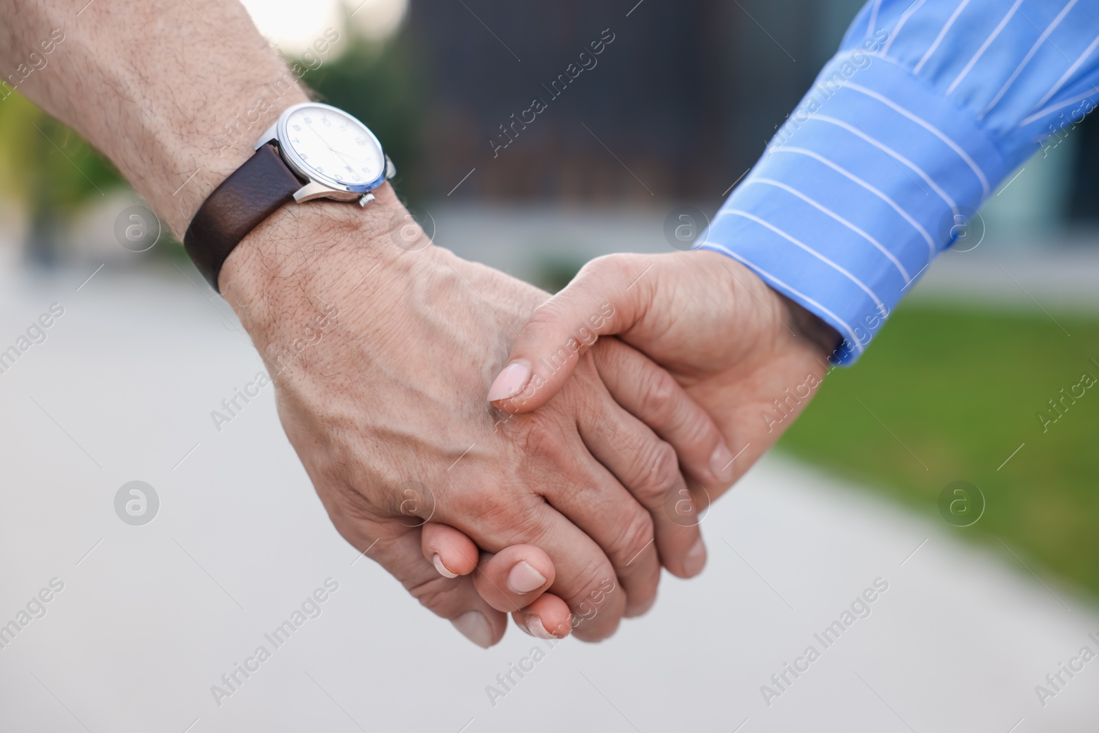 Lovely senior couple walking together outdoors, closeup Photo of Lovely senior couple walking together outdoors, closeup