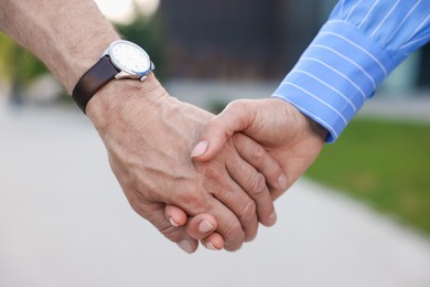 Photo of Lovely senior couple walking together outdoors, closeup