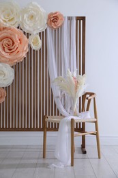 Photo of Photo zone with beautiful floral decor in studio