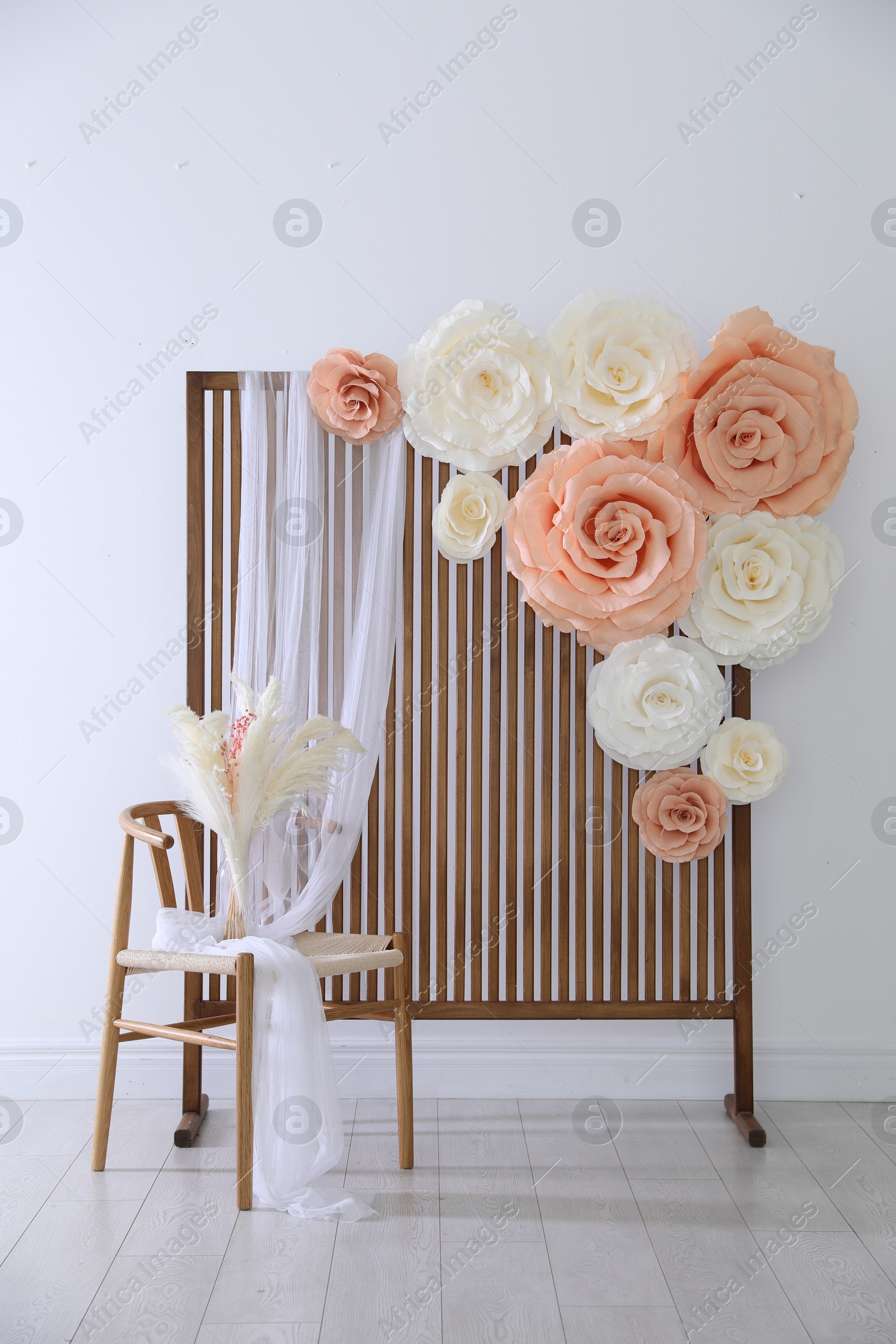 Photo zone with beautiful floral decor in studio Photo of Photo zone with beautiful floral decor in studio