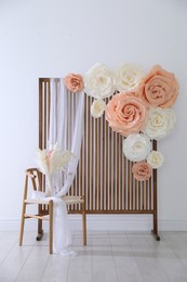 Photo of Photo zone with beautiful floral decor in studio