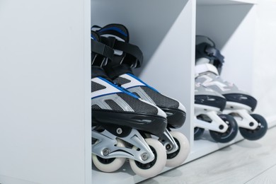 Photo of Pairs of roller skates in shelving unit, closeup