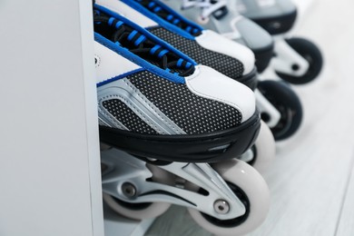 Photo of Pairs of roller skates in shelving unit, closeup