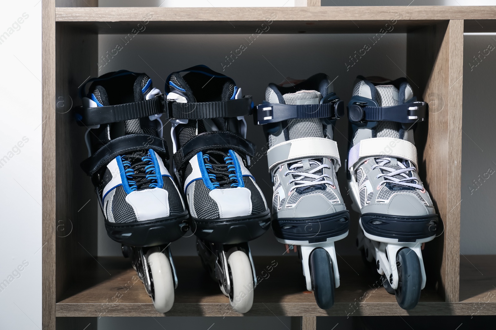 Pairs of roller skates in shelving unit, closeup Photo of Pairs of roller skates in shelving unit, closeup