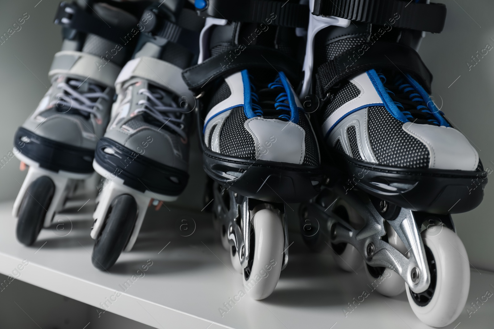Pairs of roller skates in shelving unit, closeup Photo of Pairs of roller skates in shelving unit, closeup