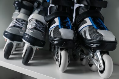 Photo of Pairs of roller skates in shelving unit, closeup
