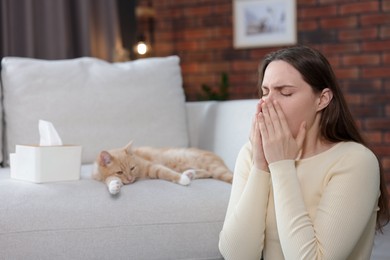 Photo of Woman suffering from allergy with her cat at home