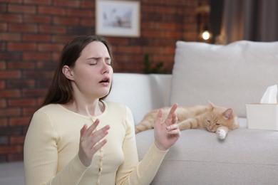 Photo of Woman suffering from allergy with her cat at home