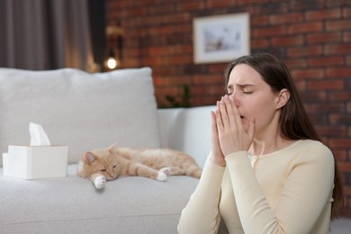 Photo of Woman suffering from allergy with her cat at home