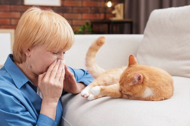 Photo of Senior woman suffering from allergy with her cat at home