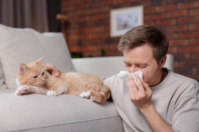 Photo of Man suffering from allergy with his cat at home