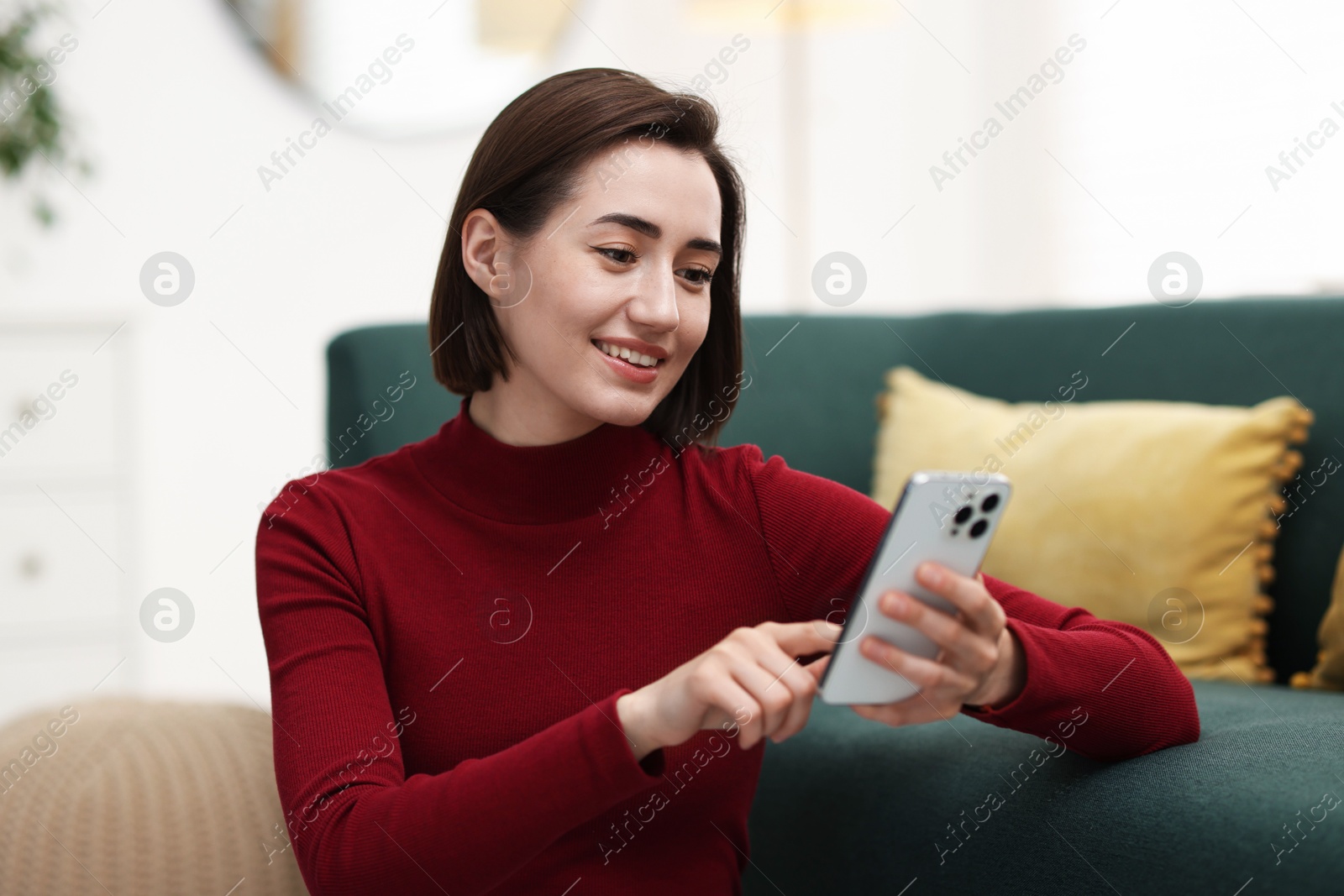 Beautiful woman using modern smartphone at home Photo of Beautiful woman using modern smartphone at home