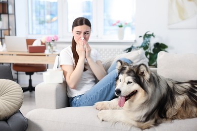Photo of Woman suffering from allergy with her dog at home