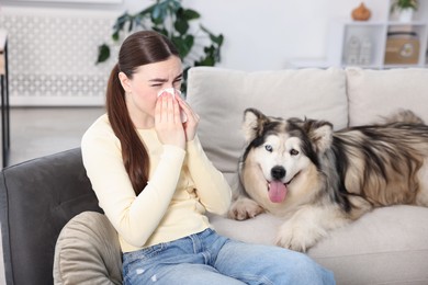 Photo of Woman suffering from allergy with her dog at home