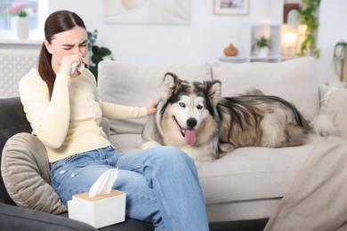 Photo of Woman suffering from allergy with her dog at home
