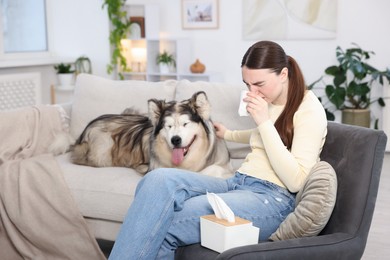 Photo of Woman suffering from allergy with her dog at home