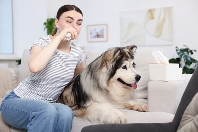 Photo of Woman suffering from allergy with her dog at home