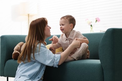Photo of Happy mother spending time together with her son at home