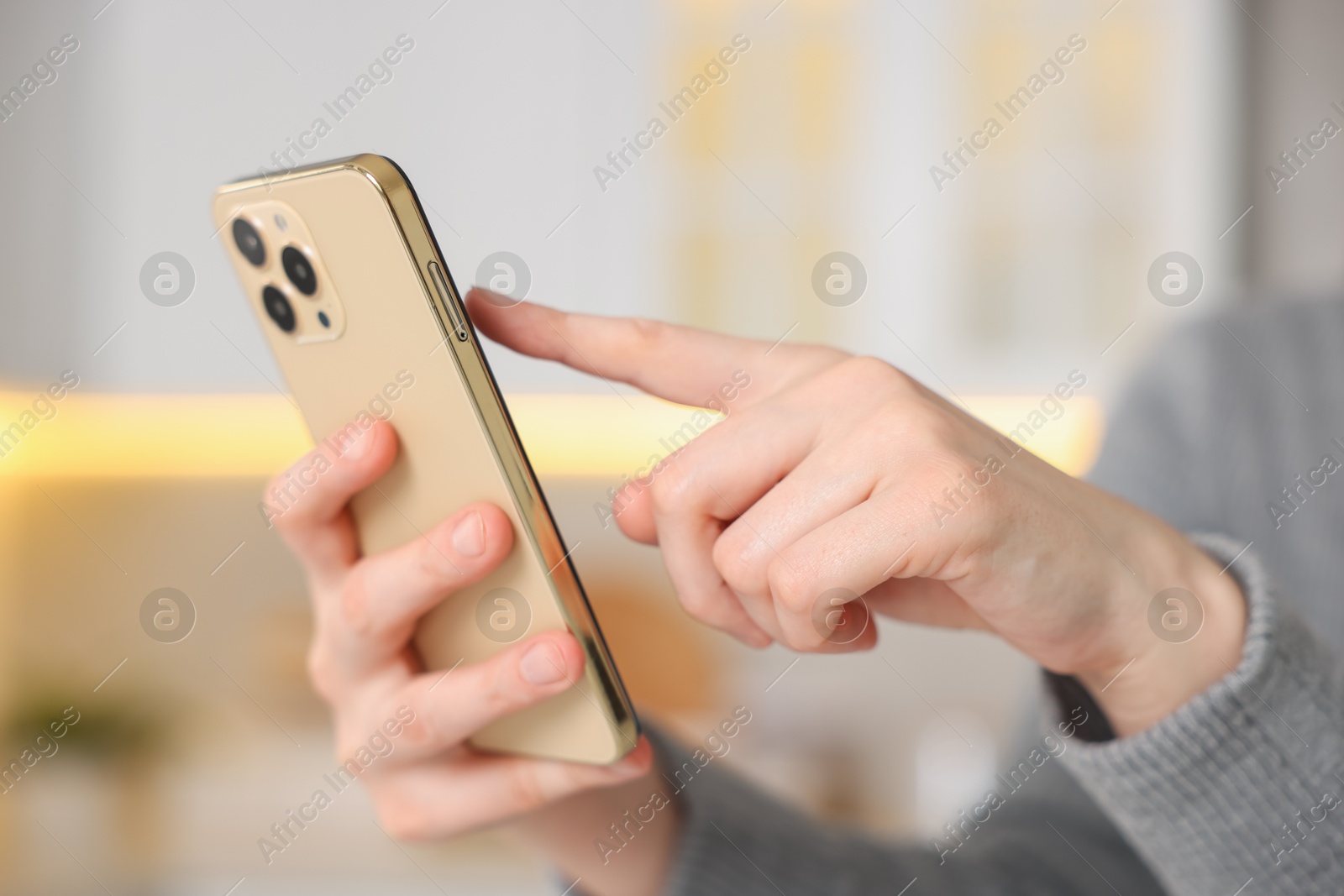 Woman using modern smartphone at home, closeup Photo of Woman using modern smartphone at home, closeup