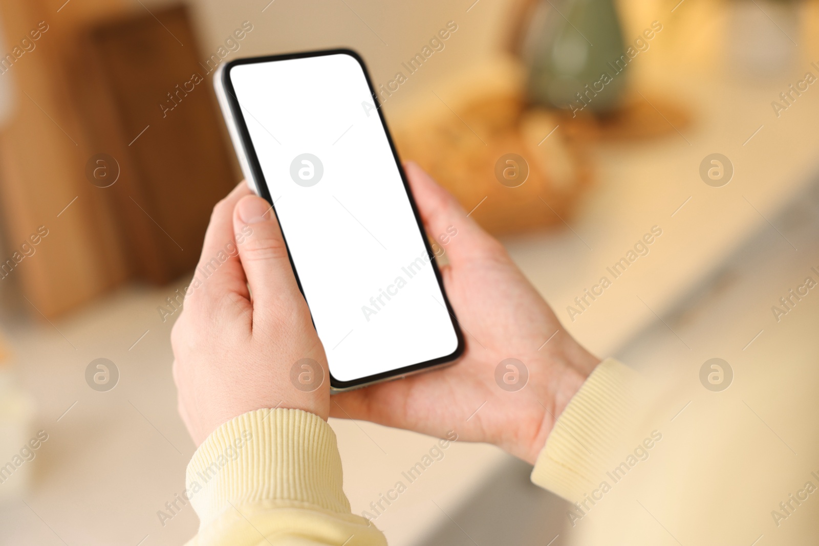 Woman using modern smartphone at home, closeup Photo of Woman using modern smartphone at home, closeup