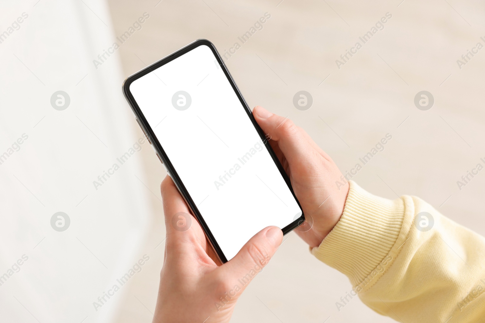 Woman using modern smartphone at home, closeup Photo of Woman using modern smartphone at home, closeup