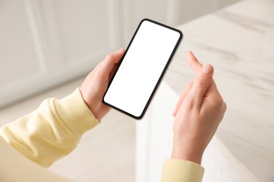 Photo of Woman using modern smartphone at home, above view