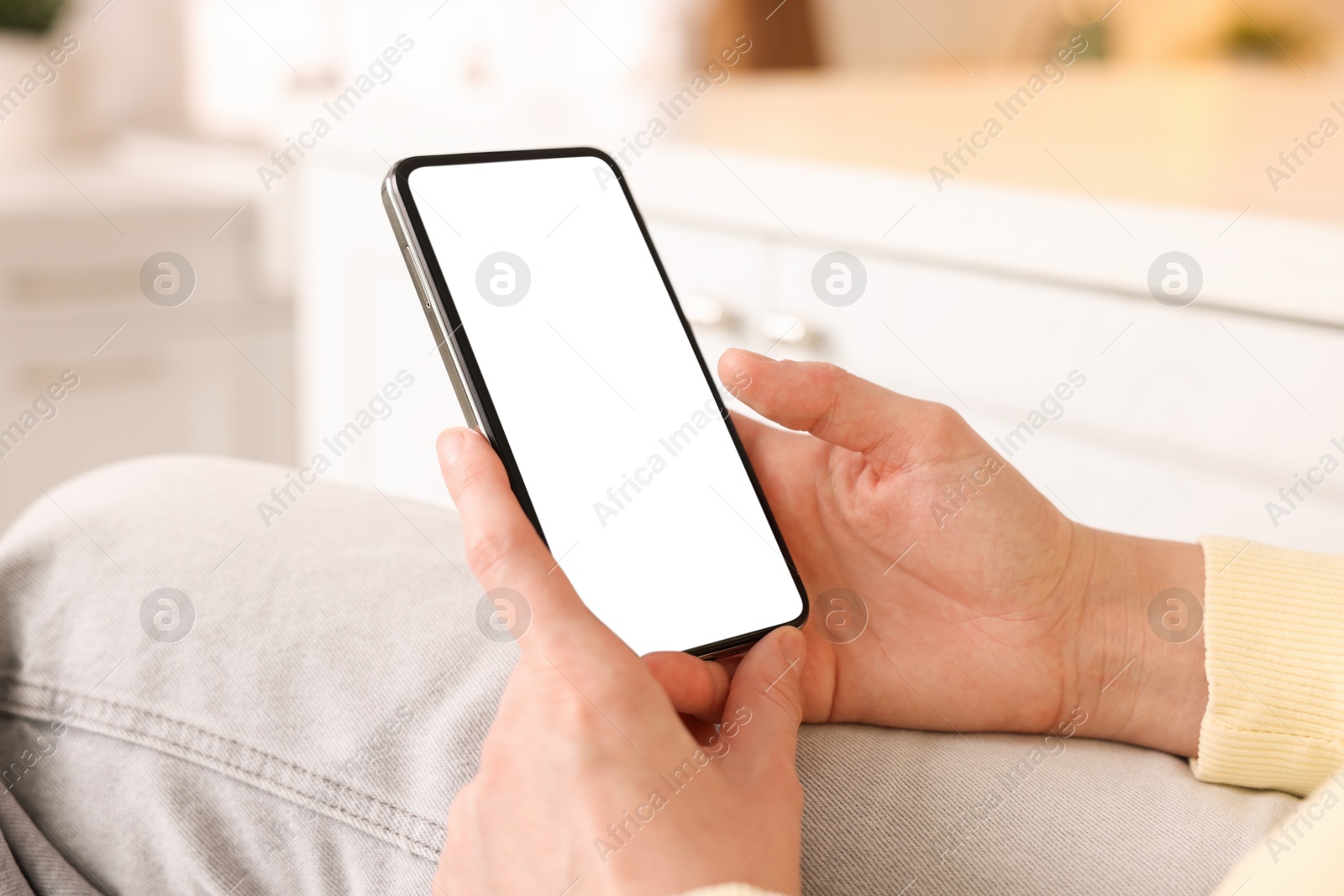 Woman using modern smartphone at home, closeup Photo of Woman using modern smartphone at home, closeup
