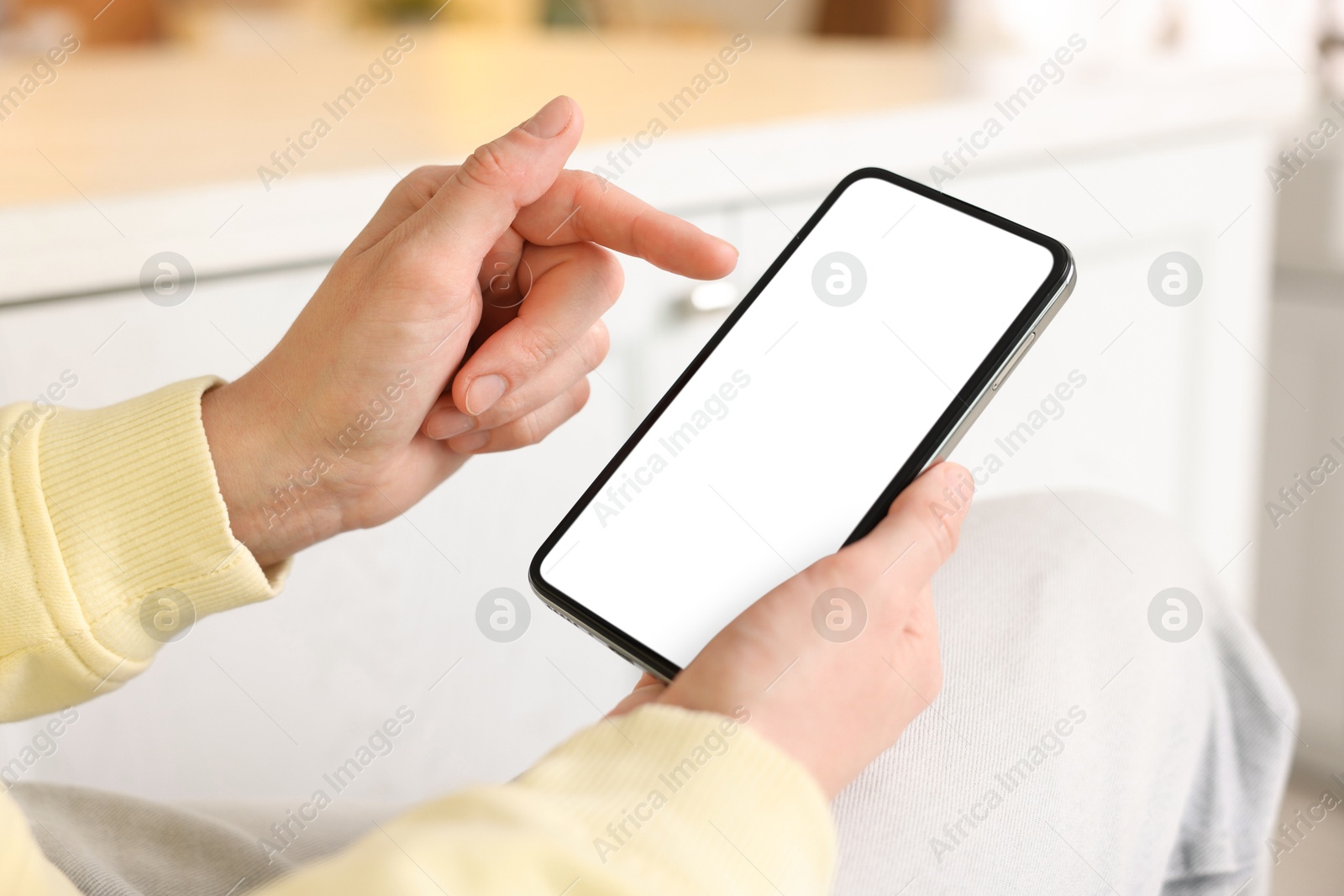 Woman using modern smartphone at home, closeup Photo of Woman using modern smartphone at home, closeup