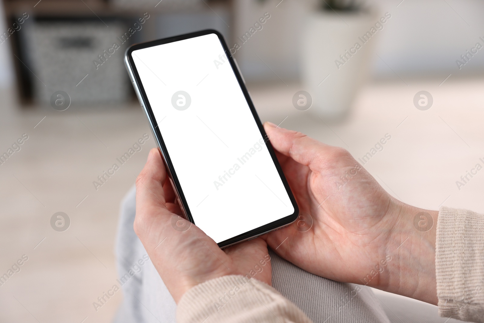 Woman using modern smartphone at home, closeup Photo of Woman using modern smartphone at home, closeup