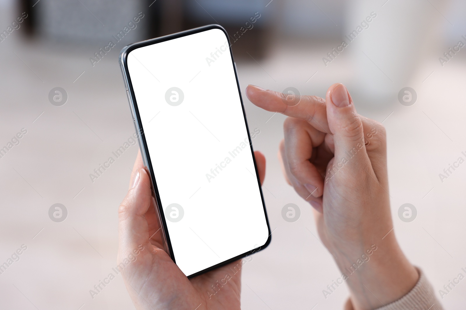 Woman using modern smartphone at home, closeup Photo of Woman using modern smartphone at home, closeup