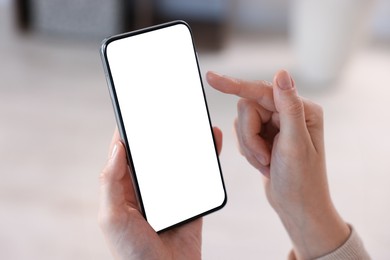 Photo of Woman using modern smartphone at home, closeup