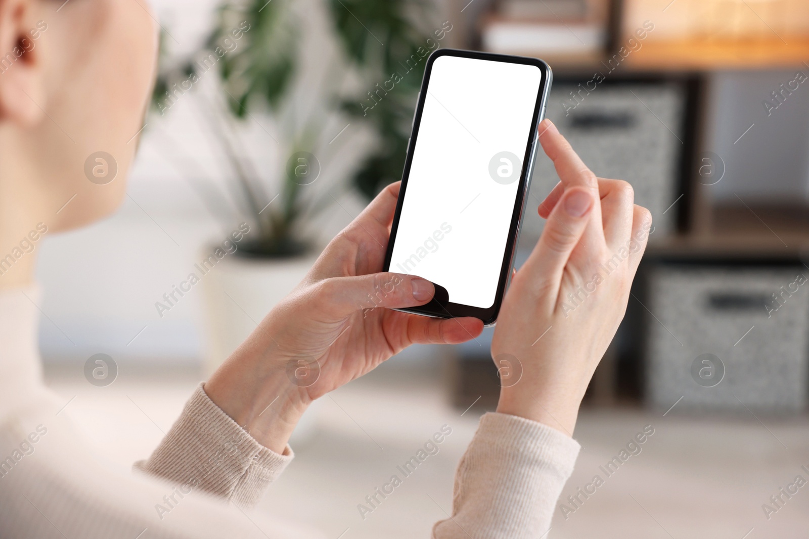 Woman using modern smartphone at home, closeup Photo of Woman using modern smartphone at home, closeup