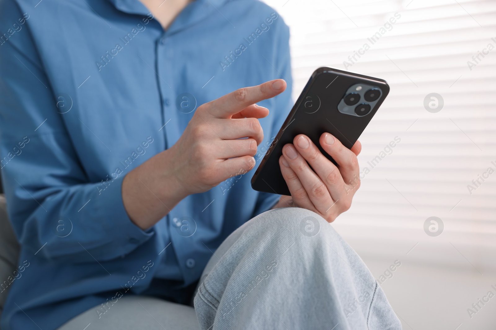 Woman using modern smartphone at home, closeup Photo of Woman using modern smartphone at home, closeup