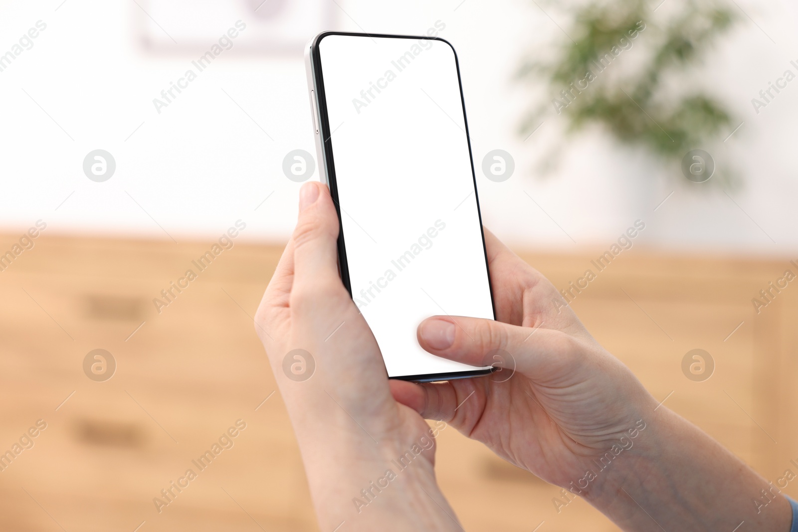 Woman using modern smartphone at home, closeup Photo of Woman using modern smartphone at home, closeup
