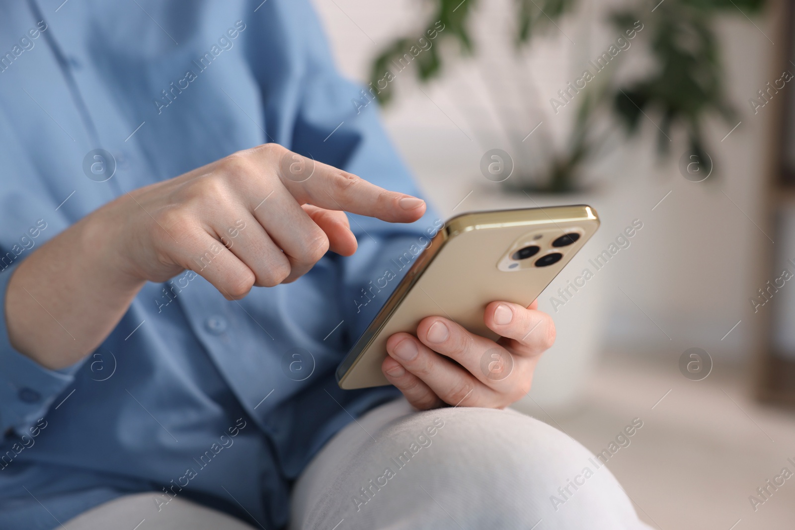 Woman using modern smartphone at home, closeup Photo of Woman using modern smartphone at home, closeup
