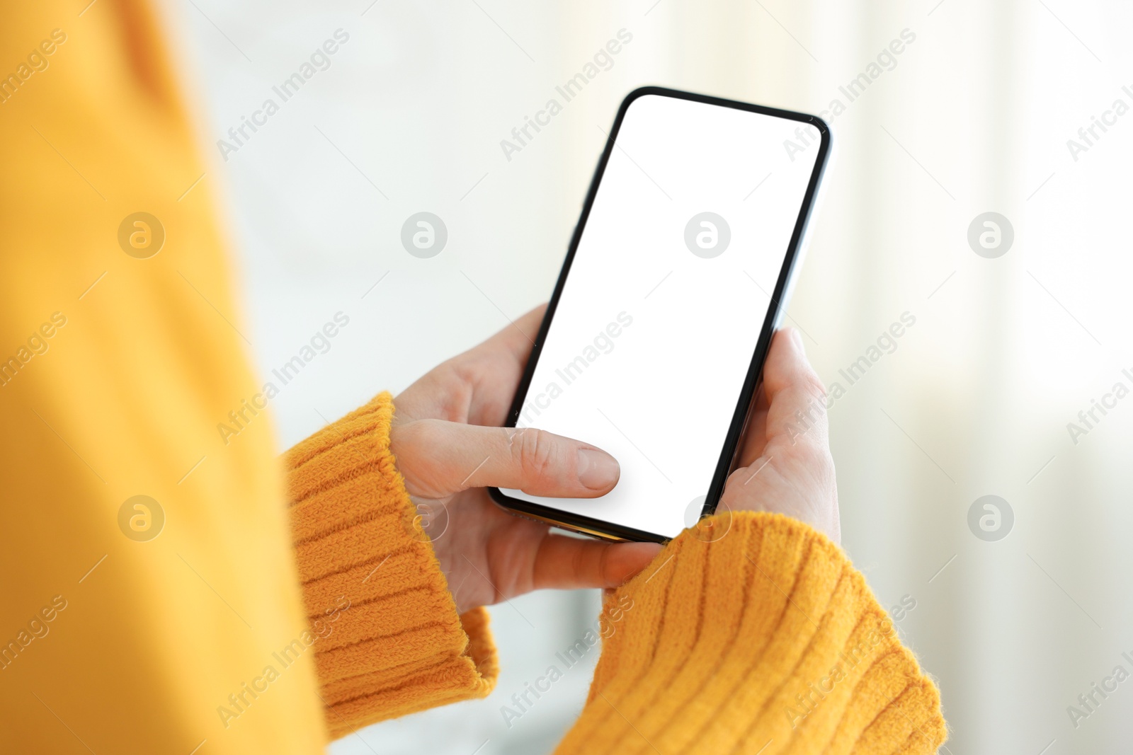 Woman using modern smartphone at home, closeup Photo of Woman using modern smartphone at home, closeup