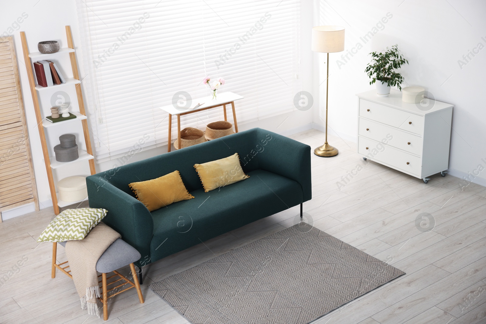 Photo of Comfortable sofa with cushions in room, above view