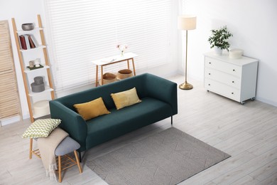 Photo of Comfortable sofa with cushions in room, above view