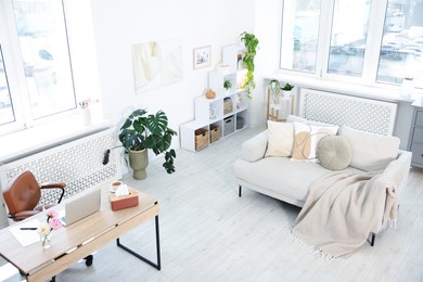Photo of Desk with laptop in stylish room, above view